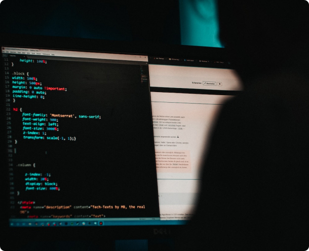 A person is looking at a computer screen with code on it.