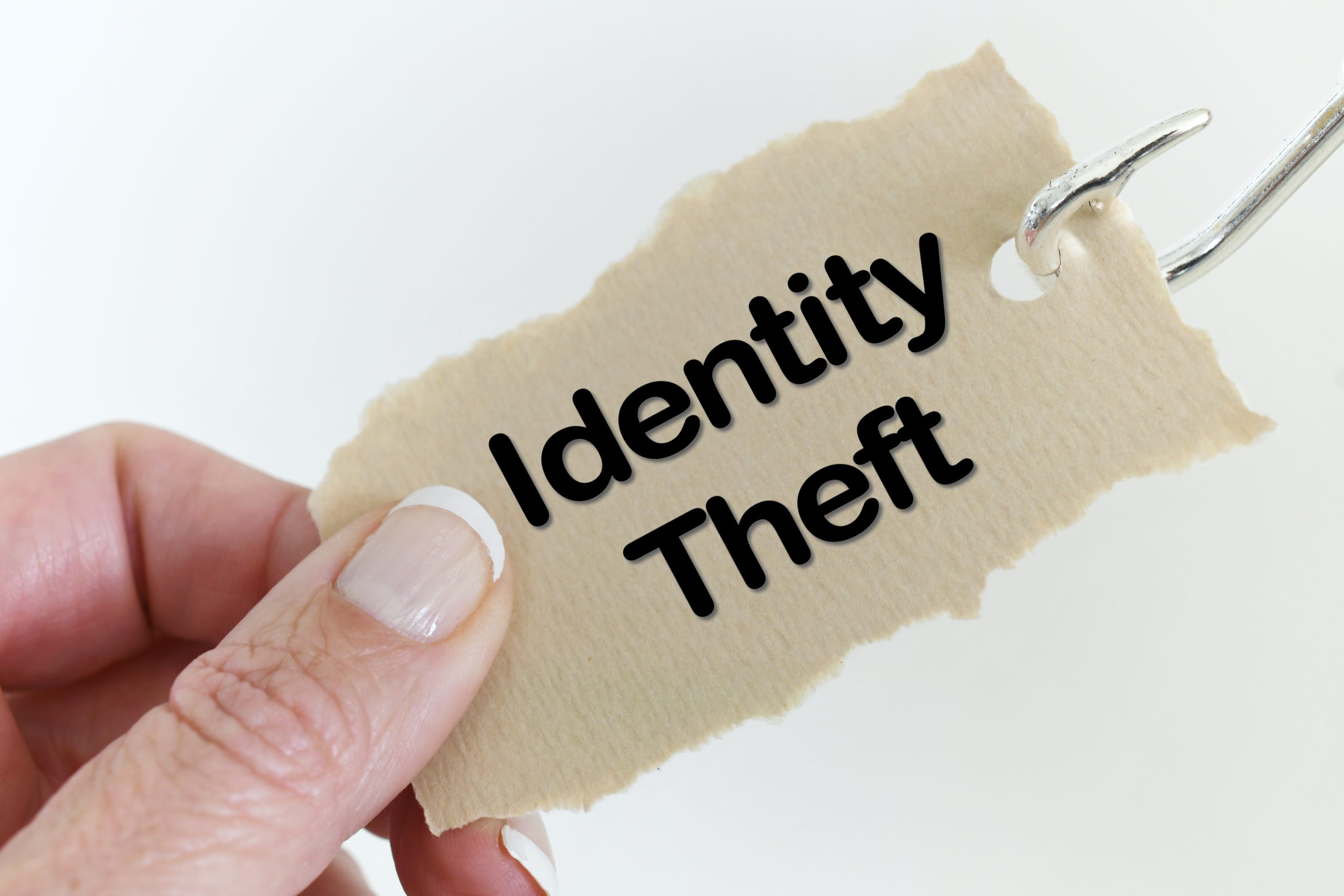 A person holding a piece of paper that says identity theft.
